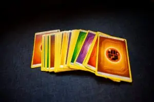 From above of colorful pack of trading cards for game placed on gray surface